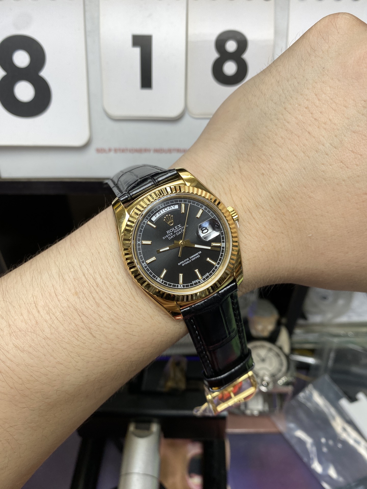 Rolex Day-Date Series 118135, Black Dial Gold Case with a leather strap, 36mm size.